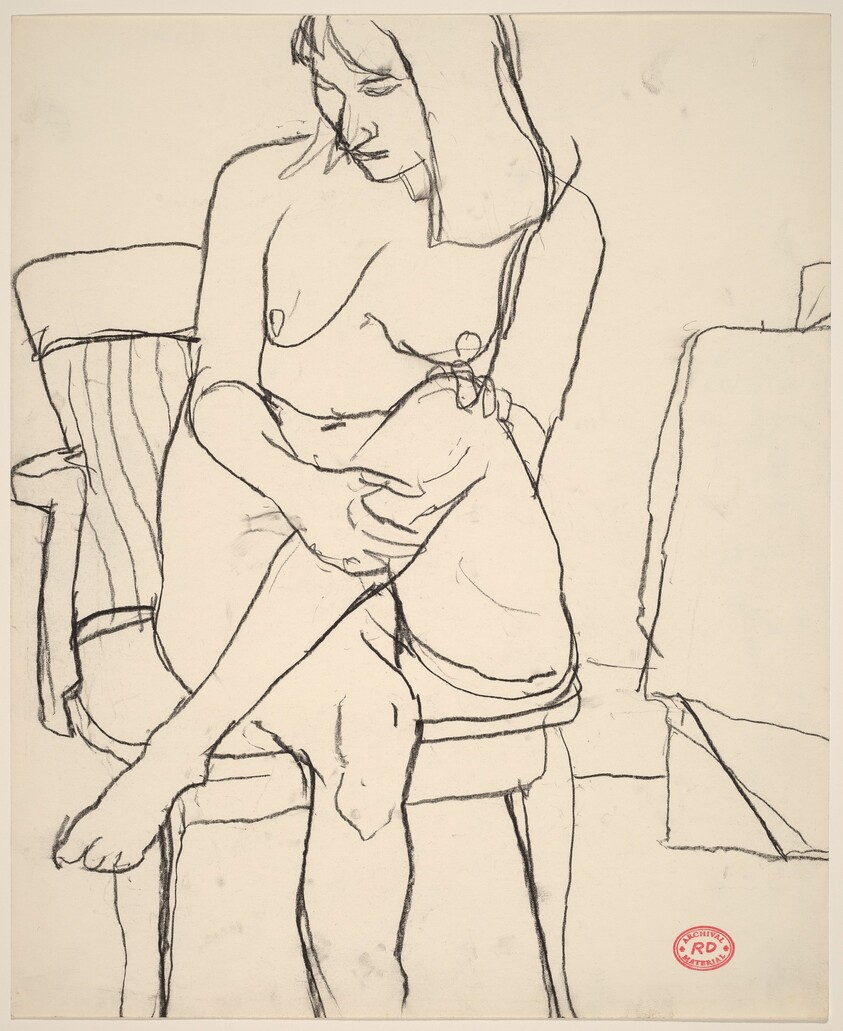 Untitled [female nude seated in armchair with legs crossed]
