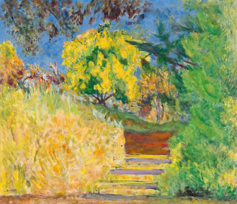 Profusions of lemon yellow and lime green represent bushes and trees against a vivid blue sky in this nearly square, loosely painted landscape. The lower left quadrant of the canvas is filled with a shrub painted with bright and warm yellow. A spring-green tree rises the height of the composition to the right, taking up that quarter of the canvas. Three steps between the two are painted buttercup yellow on the risers and lilac purple on the treads. A copper-orange and brick-red rectangular area above this could be a patch of dirt under a ribbon of green, presumably grass. A tree with a canary-yellow and shamrock-green canopy is just to left of center in the distance and is flanked by smaller trees painted with violet and marigold orange. The branch of a tree mostly out of view dips into the scene in the top left corner against the ultramarine-blue sky. The artist signed the painting in the lower left corner, “Bonnard.”
