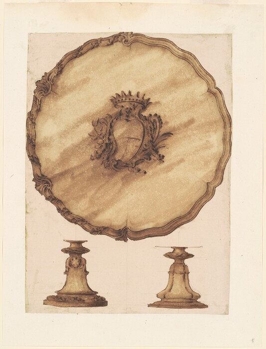 This is a drawing of a decorative tabletop standing on two ornate bases. The tabletop is oval with intricate detailing around the edges and features a central crest or coat of arms with floral and leaf motifs. Below are two pedestal bases with ornamental detailing. The drawing is in a sepia tone, giving it an aged appearance.