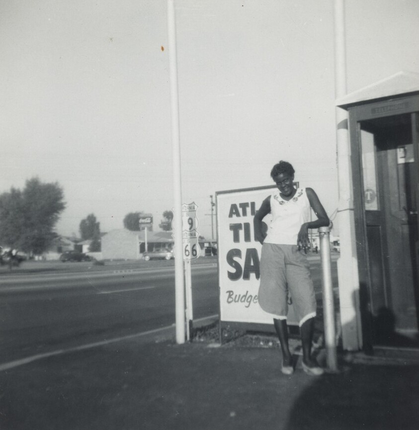 Untitled (Woman standing in front of sign)