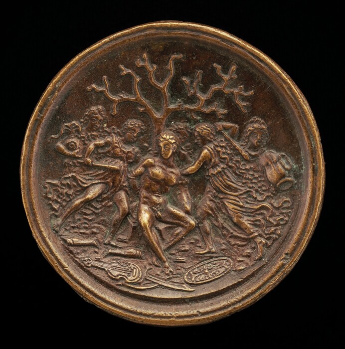 The sculpture features a circular plaque depicting a dynamic scene with multiple figures in motion. At the center of the composition appears a male figure, surrounded by three other figures. To the left, one figure holds an object resembling a mask or face, while to the right, another figure carries what looks like a rounded vessel. In the background, a tree with intricately detailed branches extends upwards. The material of the sculpture is bronze, giving it a predominantly dark brown coloration with areas of lighter golden highlights. The figures are rendered in relief, creating a three-dimensional appearance.