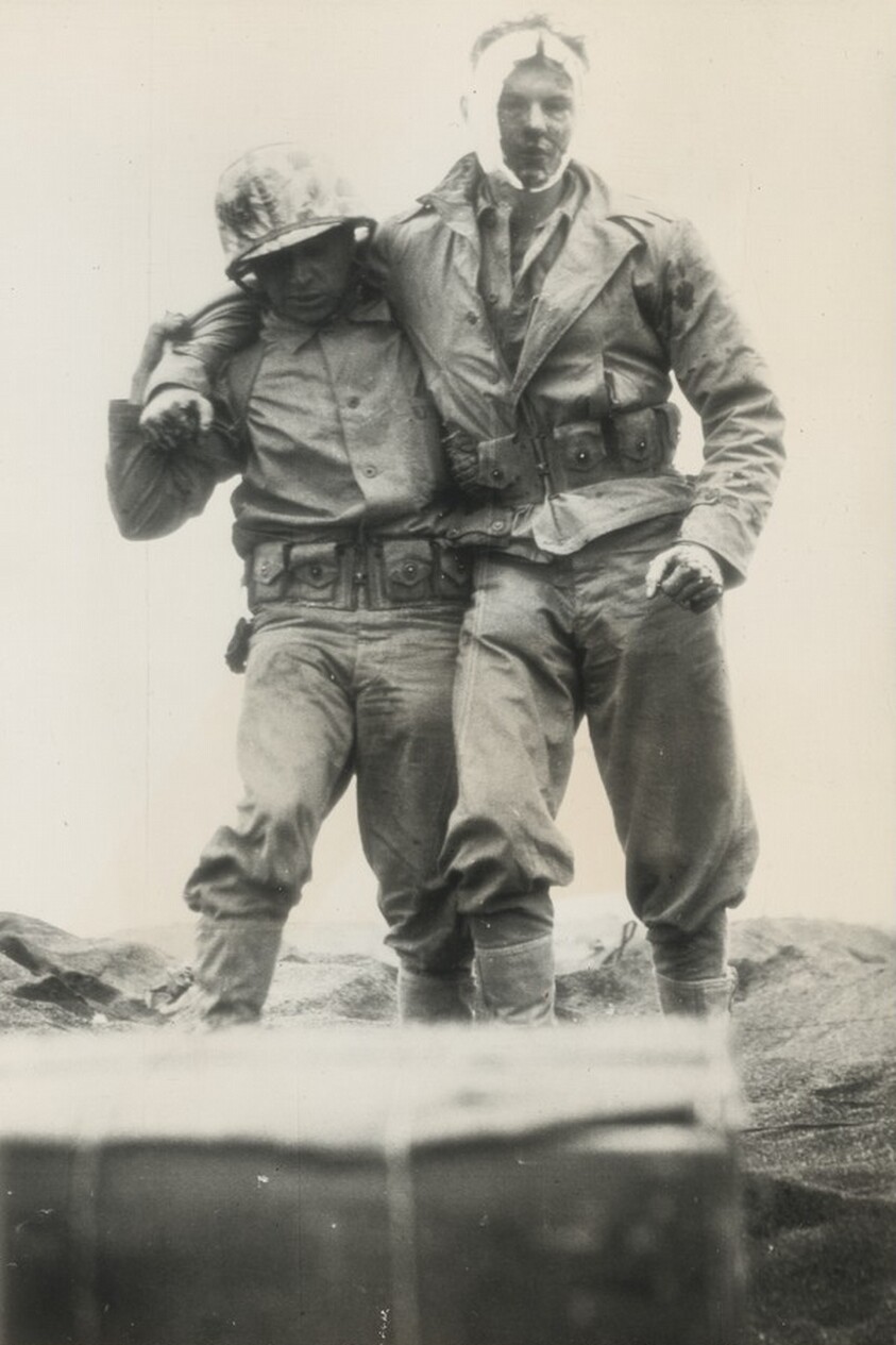 Title from caption on object: “Wounded Marine Helped from Iwo Jima”