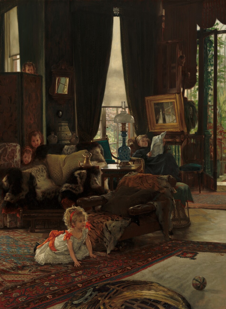 A young girl whose blond curls catch the sunlight in an otherwise dim living room looks up from a kneeling position on all fours on the floor, as the faces of three other children peek over pieces of furniture behind her in this vertical painting. The children and the woman all have peachy, pale skin. The young girl’s body is angled to our right and she looks in that direction with eyebrows raised. She has a pointed nose, rounded cheeks, and her rosebud lips are closed. Her mass of blond curls is held back with a scarlet-red ribbon, and more red ribbons are tied into bows at the shoulders of her short-sleeved, white dress and around her waist. Her dress has lacy ruffles down the front and along the bottom hem. She kneels on a large rug patterned densely with burgundy-red, denim-blue, and ivory-white stylized flowers, vines, and leaves. A red, blue, and white striped ball rests on a second patterned rug in front of her, to our right. In front of the girl and along the bottom center of the painting is a round but indistinct object, like a flattened basket, that sits on or is part of the carpet. A brown' leather chaise lounge behind the girl is covered with at least one tiger’s pelt. A wooden side table separates that chair from another overstuffed armchair covered with more furs. Next to it, a third chair with a red paisley pattern against a white background is mostly cut off by the left edge of the canvas. Almost lost in shadow, two small faces peek out from between the two leftmost chairs. Both children have rounded cheeks and they look toward the kneeling girl. The forehead and nose of a fourth child’s face peeks over tiny fingers hooked along the top of the screen behind that pair. All three have brown hair pulled back in headbands. Farther back in the room to our right, a young woman with light brown hair, wearing a dark, long-sleeved, high-necked dress, reads a newspaper with her feet propped on a footstool in the back corner. A tall window behind her, to our left, is partially covered by a sheer white shade, and a glass door on the adjoining wall, to our right, opens onto a conservatory or greenhouse filled with green plants. The windows are framed covered by moss-green curtains. More side tables, chairs, and footstools line that back space. A long-necked, blue and white lamp with a glass shade sits on the side table next to the chair with the tiger pelt, and a gold teapot with white teacups and urns sit on other tables. A small, square mirror reflects bright sunlight next to the screen and another mirror with a wide, gold frame hangs above the reading woman and reflects the window panes behind her. The artist signed the work near the lower right corner, “J.J. Tissot.”