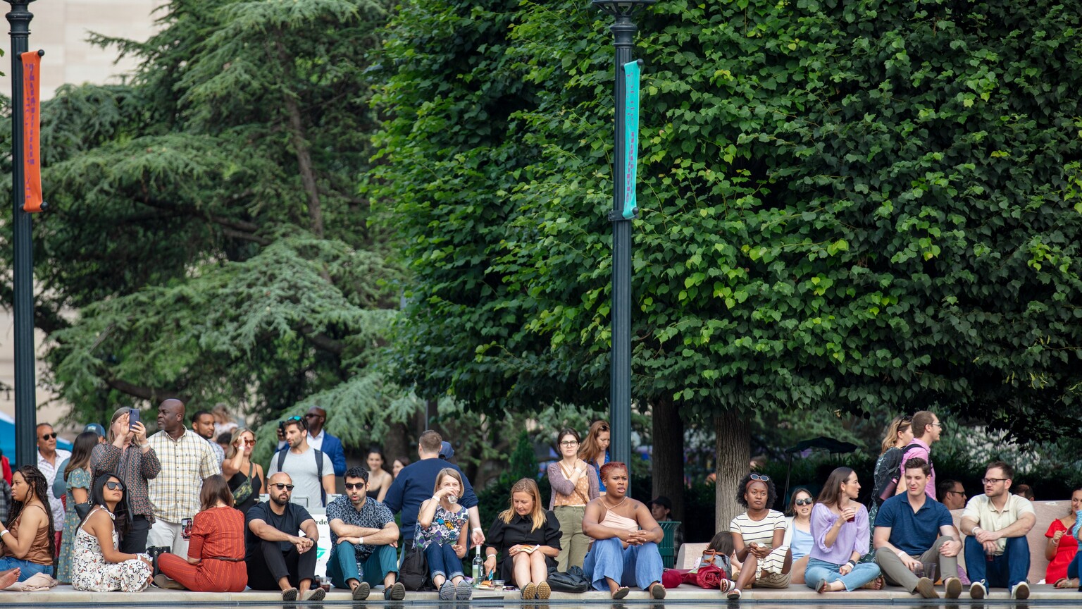 A crowd of people sitting and standing during the National Gallery's Jazz in the Garden.