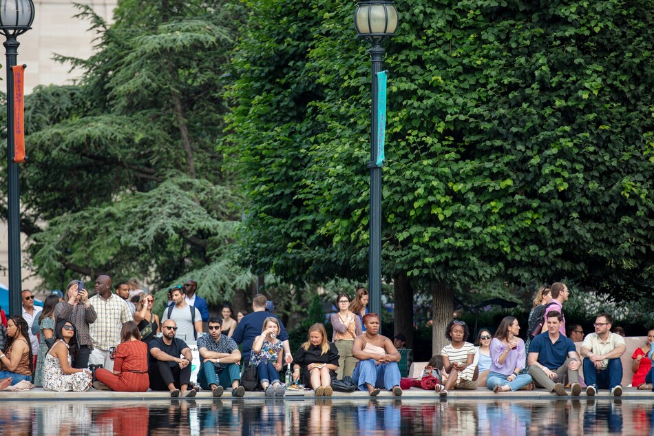 A crowd of people sitting and standing during the National Gallery's Jazz in the Garden.