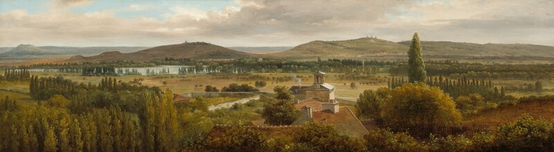 We look across the tops of trees down onto the roofs of a cluster of buildings and then a grassy expanse, a body of water, and rolling hills in this notably wide landscape painting. The trees are painted with shades of pine and olive green. At the center of the composition, the roofs are muted terracotta red with white chimneys except for the farthest structure, which has a gray roof around a lantern, perhaps indicating a church. Smoke puffs out of one chimney there. Trees with round canopies dot the pale, grassy field beyond that, which leads back to rows of tall, dark green cypress trees. A ribbon of ice blue across the left third of the painting indicates a body of water before russet-brown and muted sage-green hills roll into the deep, hazy distance. The horizon comes about two-thirds of the way up the painting, and glimpses of pale blue sky are visible through breaks in a blanket of pale gray and cream-white clouds above.