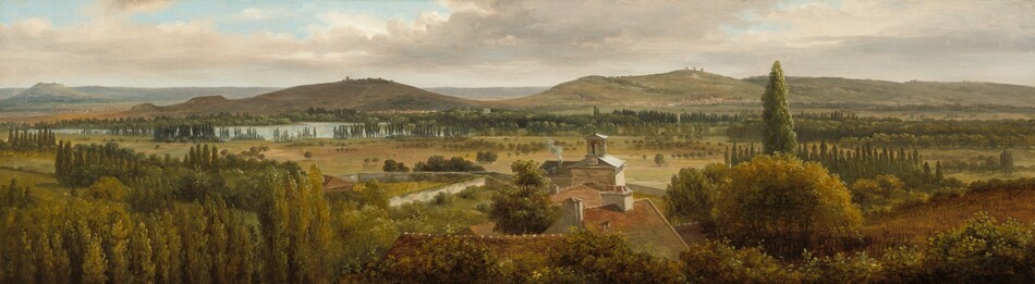 We look across the tops of trees down onto the roofs of a cluster of buildings and then a grassy expanse, a body of water, and rolling hills in this notably wide landscape painting. The trees are painted with shades of pine and olive green. At the center of the composition, the roofs are muted terracotta red with white chimneys except for the farthest structure, which has a gray roof around a lantern, perhaps indicating a church. Smoke puffs out of one chimney there. Trees with round canopies dot the pale, grassy field beyond that, which leads back to rows of tall, dark green cypress trees. A ribbon of ice blue across the left third of the painting indicates a body of water before russet-brown and muted sage-green hills roll into the deep, hazy distance. The horizon comes about two-thirds of the way up the painting, and glimpses of pale blue sky are visible through breaks in a blanket of pale gray and cream-white clouds above.