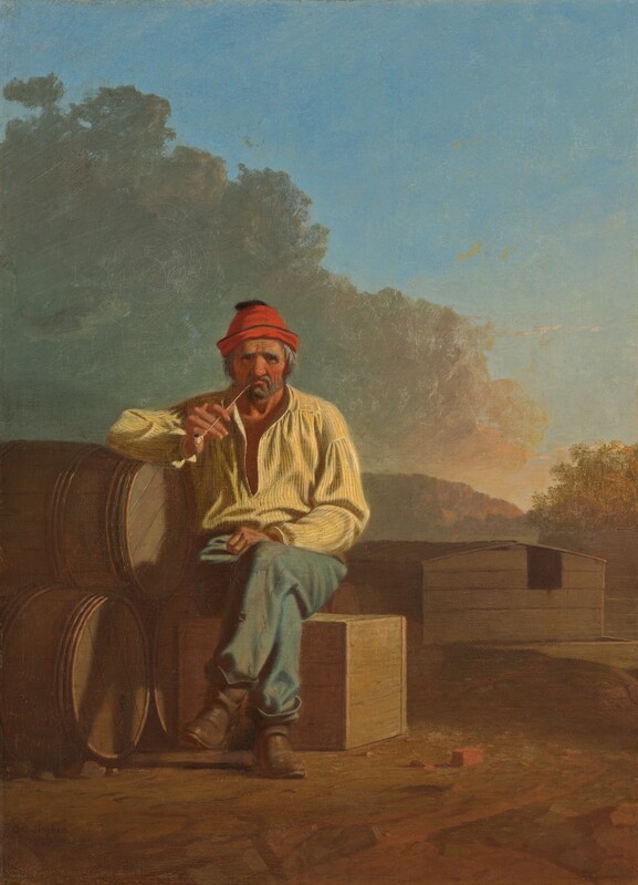 A bearded man with wrinkled, peachy skin and reddened cheeks sits and smokes a pipe on a wooden box in a landscape in this vertical painting. The man’s body faces us, and he peers at us with dark eyes under heavy, bushy white brows. Wrinkles line his forehead, the corners of his eyes, and his cheeks. He has a bulbous nose and a gray beard, and the long-stem pipe is pinched in his downturned mouth. His shaggy gray hair is covered by a cardinal-red cap. He wears a blousy daffodil-yellow shirt, which is loose around the neck, faded and patched blue pants, and scuffed brown boots. His legs are crossed with one knee over the other, and one fist rests in his lap. The other elbow is propped on a pyramid of three wooden barrels stacked on their sides to our left. A few bits of bricks or red stones are near the man’s feet, and a wooden houseboat with a low-pitched roof is in the near distance, to our right. The platform under the structure floats on a river, which is lined with trees to our right and mountains to our left. The sunset warms the face of the mountains and the trees to red and gold. Sage-green and peach clouds billow above the man, dividing the sky diagonally in front of bright blue sky beyond. The artist signed and dated the painting in the lower left corner, “G.C. Bingham 1850.”