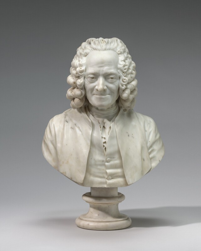 The head, shoulders, and upper chest of a man wearing a curly wig are carved from white marble in this freestanding portrait sculpture. In this photograph, the man’s body and face are squared to us but his eyes cut to our right. His high forehead is lined, and there are crow’s feet around his eyes and wrinkles down the sides of his mouth. His thin lips are pulled up in a slight smile. The hair of his wig is brushed back, and it falls in tiers of dense curls to his shoulders. A white cloth is tied around his sinewy neck, and ruffles peek from the opening of his buttoned vest under his coat. The bust is curved along the bottom edge and sits on a round, stone pedestal. The sculpture is photographed against a gray background.