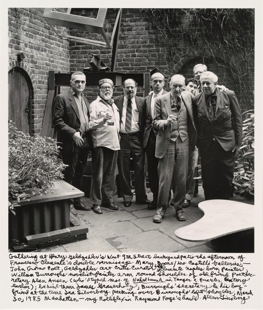 Gathering at Henry Geldzahler's West 9th street backyard patio the afternoon of Francesco Clemente's double vernissage Mary Boone/Leo Castelli Galleries,-- John Giorno Poet, Geldzahler art critic curator self Clemente Naples born painter William Burroughs novelist-painter arm round shoulder of old friend poet secretary Alan Ansen (who'd typed mss. of _Naked Lunch_ in Tangier a quarter Century earlier); behind them James Grauerholz, Burroughs' secretary  & his boyfriend at the time Ira Silverberg peeking over Burroughs' left shoulder, March 30, 1985 Manhattan-- my Rolleiflex in Raymond Foye's hands.