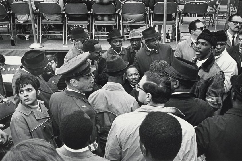 Surrounded by supporters, advisors, and security personnel, Dr. King, Jr. prepares for his speech at the United Nations