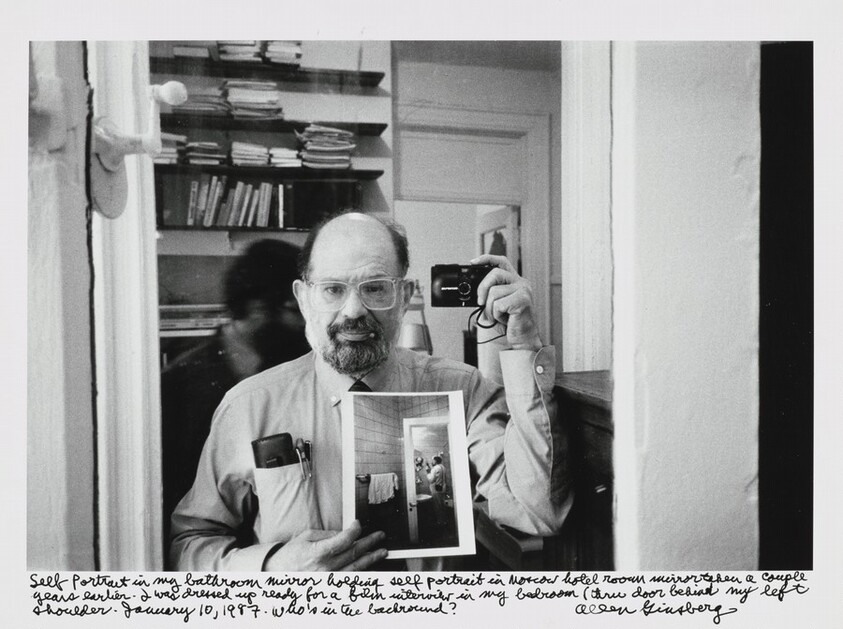Self Portrait in my bathroom mirror holding self portrait in Moscow hotel room mirror taken a couple years earlier. I was dressed up ready for a film interview in my bedroom (thru door behind my left shoulder. January 10, 1987. Who's in the background?
