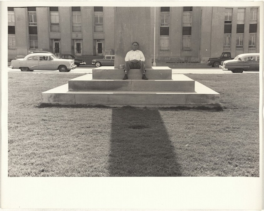 Man sitting on steps of monument--Casper, Wyoming