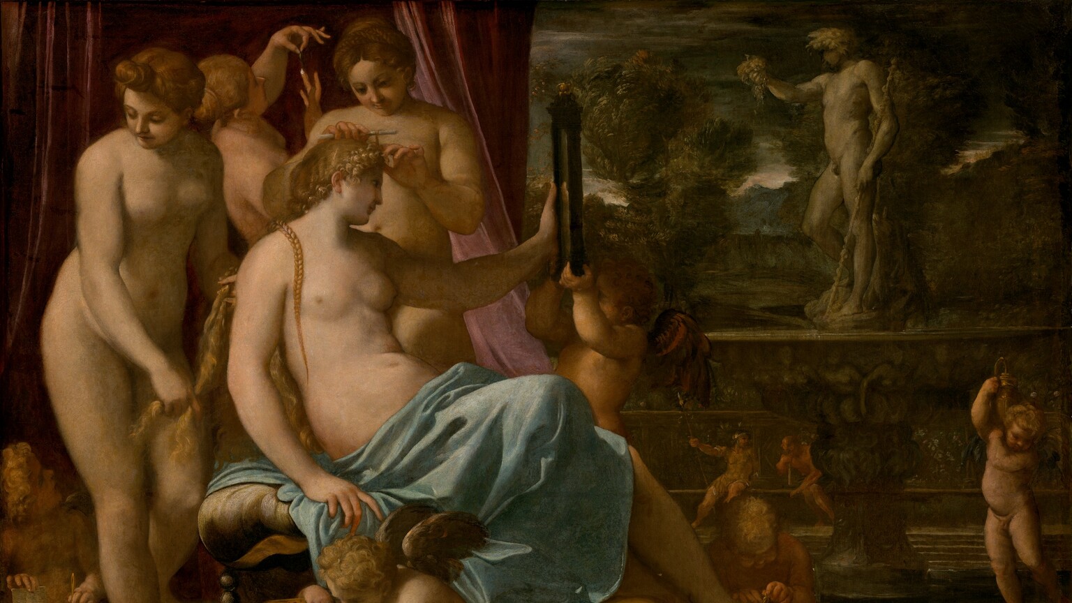 In the left half of this horizontal painting, a bare-chested, seated woman, Venus, is tended by three nude women and several child-like, nude, winged putti. All the women and putti have pale, peachy skin. To our right, a statue of a man stands on an ornately carved pedestal on a veranda in front of a distant landscape. Venus sits facing our right and she looks into a rectangular, black-framed mirror she holds up with her left hand. Her blond hair is braided and she has delicate features. A sky-blue cloth wraps around her waist and lap, and covers her legs. One foot rests on the lap of a seated putto, who ties on a sandal. Another putto helps hold up the mirror. A third putto near us, in front of Venus, pulls strings of pearls from a gold box and the fourth, in the lower left corner, lifts a comb and long needle out of a gilded, rectangular box. Two of the women behind Venus tend to her hair and the third holds up and gazes at a teardrop-shaped pearl. A dusky rose-pink curtain falls behind the women and putti. The view opens onto a terrace on the right half of the painting. A gray stone sculpture of a nude man holding up a bunch of grapes with one hand and bracing a tall stick with the other stands facing our left on an ornately carved base. The base is made up of a wide, shallow bowl above a single pedestal foot. In the distance, two people sit against a tall balustrade. The person on the left wears gold-colored armor, a helmet, and holds a long spear. The bearded man to the right appears to be nude as he leans to the side toward his companion, resting his hand and chin along a staff propped on the bench's seat. Trees and mountains in the landscape beyond are painted with brown, deep gray, and forest and sage green. A sliver of white sky along the horizon brightens an otherwise steel-gray sky.