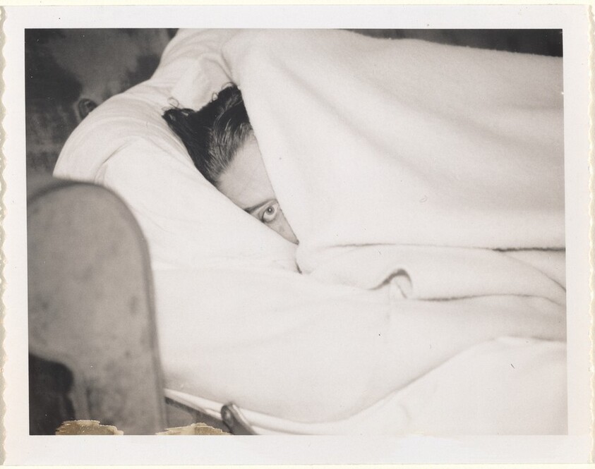 Untitled (Woman's face between blankets)