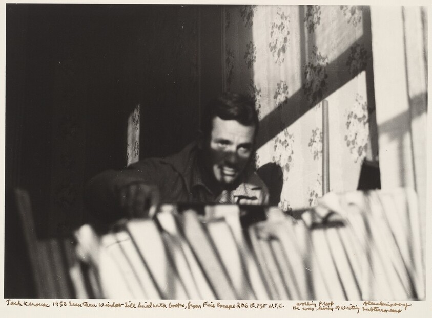Jack Kerouac 1953 Seen through window sill lined with books, from Fire Escape 206 E. 7 St. N.Y.C. He was living or writing Subterraneans