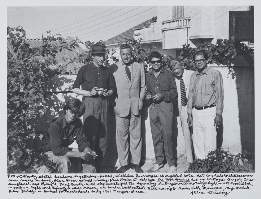 Peter Orlovsky seated handsome mysterious-haired, William Burroughs thoughtful with hat to shade Mediterranean sun, camera in hand, Alan Ansen relaxed visiting from Venice to help type _The Soft Machine_ cut-up writings, Gregory Corso sunglassed and Minox’d, Paul Bowles with elegant striped tie squinting in bright mid-morning light—all assembled, myself on right with cigarette & white trousers, at garden wall outside Bill’s single room Villa Muniria, my Kodak  Retina probably in Michael Portman’s hands July 1961 Tangier Moroc.