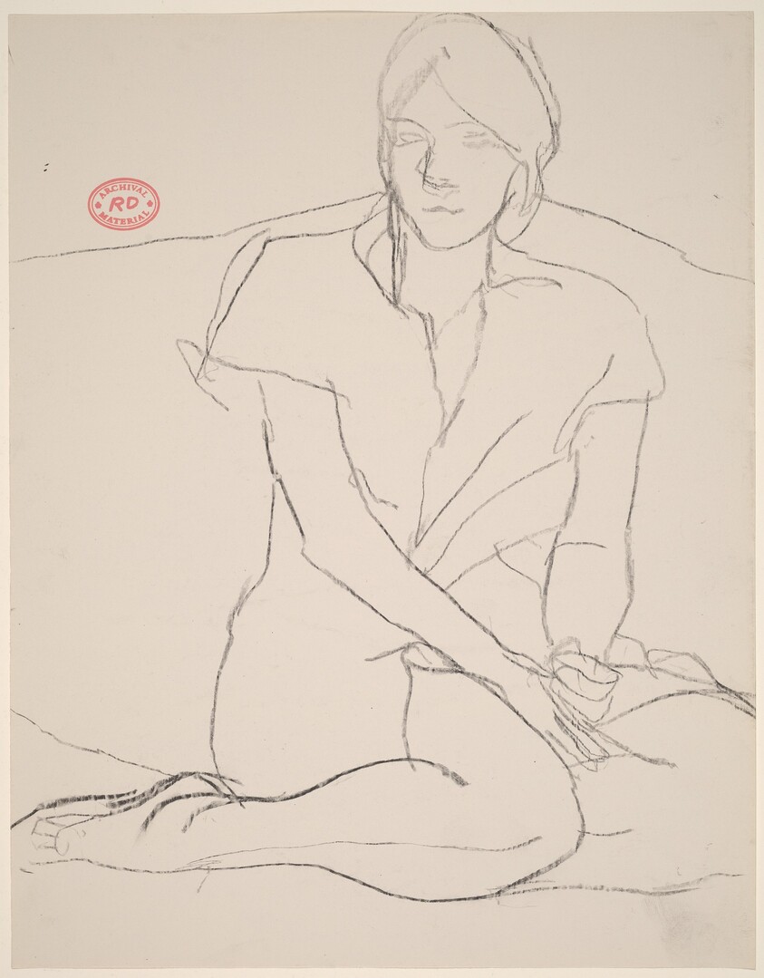 Untitled [woman seated with her legs tucked under her]