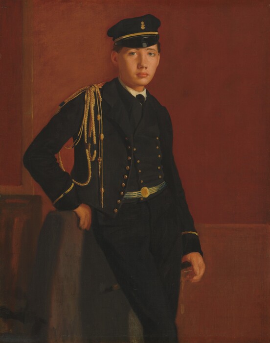 Shown from the knees up, a young man with pale, peachy skin, wearing a black uniform and cap, leans against the back of a chair in this vertical portrait painting. He looks at us with pale blue eyes under sloping brows. He has an oval face, a rounded nose, and the corners of his closed mouth turn slightly down. His cap has a narrow, rounded, shiny black brim, a gold band around the crown, and a gold embellishment at the front center. The white collar of his shirt is visible along the neckline of his vest, which fastens with two lines of gold-colored buttons. His black jacket, also lined with gold buttons, hangs open. Braided gold ropes are looped under his arm from his right shoulder, to our left. More gold ropes hang down almost to his waist from that shoulder. He has a sky-blue and gold striped belt with a gold medallion at the front center over his vest. Gold bands encircle the wrists of both jacket sleeves, and his trousers are black. His right hand, to our left, rests against the back of the chair, with his palm facing away, and he leans that hip against those fingers. The chair has a coffee-brown back. He rests his other hand by his side, possibly on the hilt of a dagger or sword hanging from his far hip. The wall behind him is rust red.