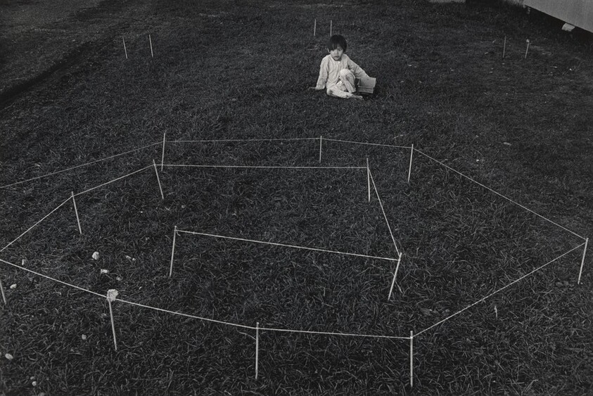 Girl with maze game, Indiantown Gap. The object was to drive a toy truck into the center