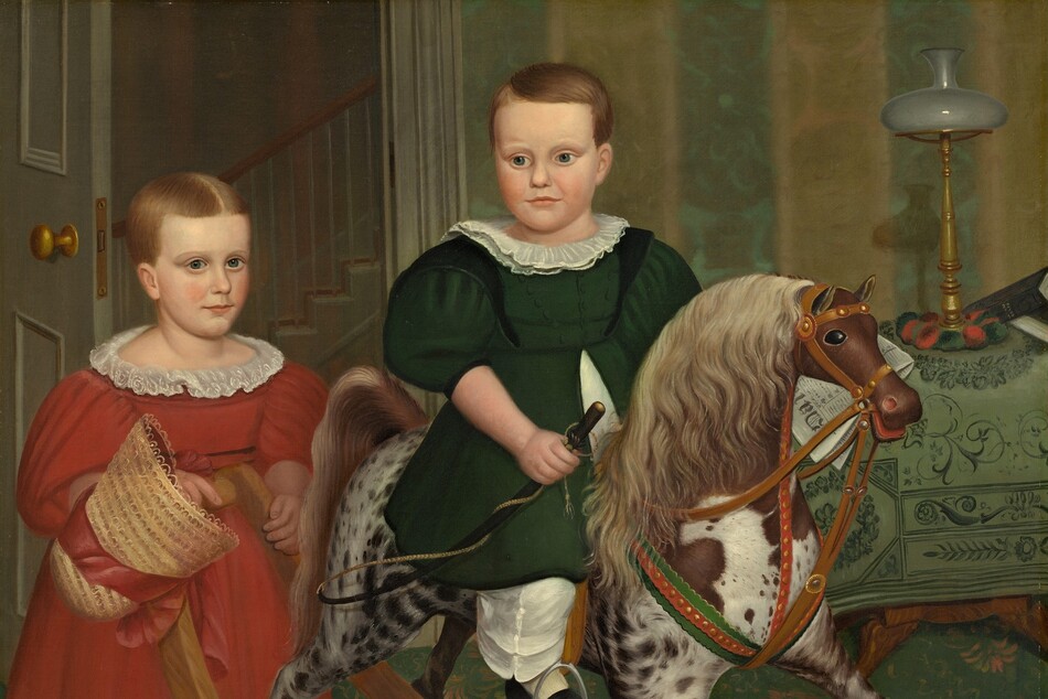 Two children with pale, peachy skin stand and sit on a rocking horse in a wallpapered interior in this square painting. Both children have short, honey-brown hair, high foreheads, dark blue eyes, and small, rounded noses. Their cheeks are smooth and the corners of their thin, pale pink lips curl slightly up. Both wear dresses with puffy, elbow-length sleeves, white collars, calf-length skirts, and wide, white pantaloons over white stockings. At the center of the composition, one child sits astride the rocking horse, which faces our right in profile. The skirt of the forest-green dress splits at the waist to fall open on either side of a white garment underneath. That child’s head turns back over one shoulder to look down and to our left. One black shoe rests in a stirrup, and the child holds a riding crop in one hand. The horse is dappled with fawn brown and white, and has a parchment-brown mane and tail. The horse’s eye we can see is black and its red mouth is open around the bridle and reins. The second child stands at the back of the rocking horse, hands resting on the crossbar that connects the toy's long, curving rockers. That child wears a crimson-red dress and holds the red ribbon of a straw bonnet in one hand. The hair is parted down the middle and that child looks at us. A black cap with a curved, shiny visor and tassels hanging from the crown rests on the base of the rocking horse. The rug has a stylized, terracotta-orange floral pattern against a pine-green background. The wall behind the children is striped with wide bands of golden yellow and moss green. A door with a gold-colored doorknob is swung inward to our left, behind the child in red, to reveal the profile of a staircase beyond. To our right, just behind the horse’s head, a wooden table is draped with a cloth patterned with vines and leaves in dark green against a pea-green background. A lamp with a tall, spindly brass base is topped with a squat, round white globe. A folded newspaper behind the child in green could rest on the table, or could be held by that child. An inscription on the masthead of the paper begins, “Dai.”