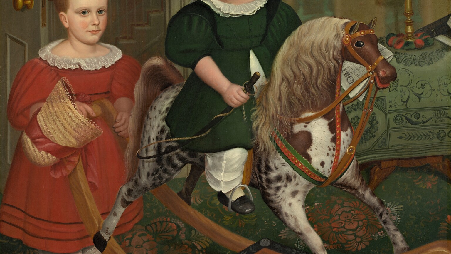 Two children with pale, peachy skin stand and sit on a rocking horse in a wallpapered interior in this square painting. Both children have short, honey-brown hair, high foreheads, dark blue eyes, and small, rounded noses. Their cheeks are smooth and the corners of their thin, pale pink lips curl slightly up. Both wear dresses with puffy, elbow-length sleeves, white collars, calf-length skirts, and wide, white pantaloons over white stockings. At the center of the composition, one child sits astride the rocking horse, which faces our right in profile. The skirt of the forest-green dress splits at the waist to fall open on either side of a white garment underneath. That child’s head turns back over one shoulder to look down and to our left. One black shoe rests in a stirrup, and the child holds a riding crop in one hand. The horse is dappled with fawn brown and white, and has a parchment-brown mane and tail. The horse’s eye we can see is black and its red mouth is open around the bridle and reins. The second child stands at the back of the rocking horse, hands resting on the crossbar that connects the toy's long, curving rockers. That child wears a crimson-red dress and holds the red ribbon of a straw bonnet in one hand. The hair is parted down the middle and that child looks at us. A black cap with a curved, shiny visor and tassels hanging from the crown rests on the base of the rocking horse. The rug has a stylized, terracotta-orange floral pattern against a pine-green background. The wall behind the children is striped with wide bands of golden yellow and moss green. A door with a gold-colored doorknob is swung inward to our left, behind the child in red, to reveal the profile of a staircase beyond. To our right, just behind the horse’s head, a wooden table is draped with a cloth patterned with vines and leaves in dark green against a pea-green background. A lamp with a tall, spindly brass base is topped with a squat, round white globe. A folded newspaper behind the child in green could rest on the table, or could be held by that child. An inscription on the masthead of the paper begins, “Dai.”