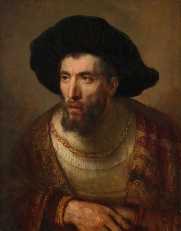 Shown from the chest up, a light-skinned man with a gaunt face, wearing a large, dark brown hat, almost fills this vertical painting. His chest faces us, leaning over his hands, which are folded along the bottom of the painting. His head turns to our left, and he looks in that direction. His deep set, hazel eyes are rimmed in pink under dark, thick brows. His long nose has a slight bump at the bridge, and his pale coral-red mouth is slightly open, creating shaded hollows under high cheek bones. His brown beard is trimmed straight across the bottom. The soft, oversized, earth-brown beret covers most of his head, leaving just a fringe of dark brown hair along his forehead. A brocaded robe with bands of rust red and gold is draped over a mustard-yellow garment with a low scooped neckline. The garment is layered over a high-necked, pleated, ivory-white undergarment. A thick gold chain hangs low across his chest, and the background is mottled with honey and tawny brown.