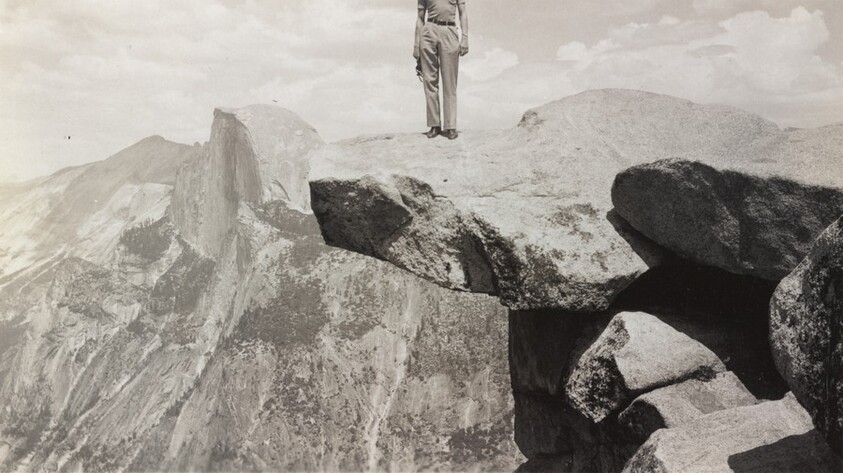 Untitled (Man standing on top of cliff)