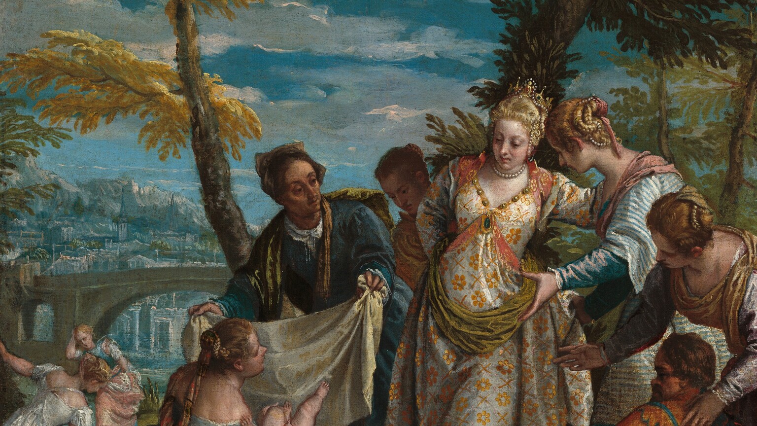 Six elegantly dressed, light-skinned women, a man with dark brown skin, and a person of short stature gather around a nude baby boy in front of a landscape with a town in the distance in this vertical painting. Attention is focused on the baby, held by a woman kneeling to our lower left, and on a woman wearing a silver and gold-colored brocade dress standing near the center of the painting. The central woman's dress is trimmed with gold and jewels. She wears a pearl necklace, and her blond hair is wrapped with pearls around a gold, jeweled tiara. She leans to our right, toward another woman with blond, pearl-adorned hair wearing a blue and white stripped dress with puffed sleeves. In front of that pair, and along the right edge of the painting, another woman with pearls in her hair bends over a person of short stature and gestures toward the baby. The person of short stature has brown hair over a high forehead and a tan complexion. He holds an instrument like a recorder and wears a navy-blue and crimson-red jester’s costume. Seen from the waist up in the lower left corner of the painting, the man with brown skin has close-cropped black hair and wears a marigold-orange garment. Looking onto the scene from the sunken riverbed, he gazes to our right in profile and holds a basket. Above him, the woman holding the baby looks at the woman wearing silver and gold. An older woman holds up a cloth, presumably to wrap the baby. Another person looks on over that woman’s shoulder, and two more women stand farther back to our left, apart from this group. Behind the main scene, a few spindly trees with feathery pine-green or harvest-yellow leaves extend off the top edge of the canvas. An arched bridge spans the river in the distance to the left and beyond a town is painted in blue and gray against rocky hills. Blue sky above is strewn with white clouds.