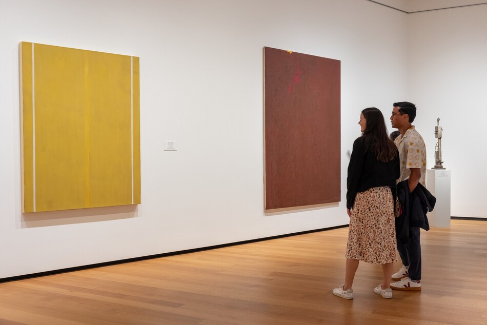 Visitors look at a painting in the National Gallery of Art.