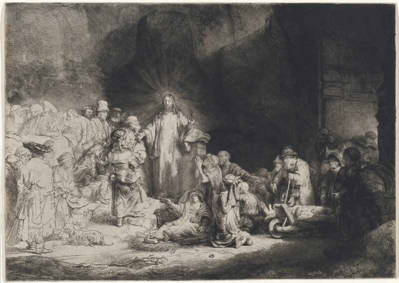 Printed with black lines and deep, velvety shading on white paper, a man, Jesus, stands at the center of a crowd of more than two dozen people, mostly adults and a few children, in this horizontal etching and drypoint. Jesus is left of center. He stands facing us, but he turns his head to look to our left. Rays of light emanate from behind his head against the towering cave opening that surrounds him. His curly hair falls long over his shoulders, and he holds both hands out. His eyes are lightly incised, giving them an almost blurred look. A crowd of people lie or kneel to our right. Some use crutches or walking sticks, and some are on carts. All the people appear to have pale skin except for one with darker-toned skin to the right in this gathering. That person has a rounded nose, full lips, and wears an earring that gleams brightly in the deep shadows. A camel stands at the far side of this group under an arched opening. The people standing and one person sitting close to Jesus to the left are fully shaded, and those farther left are lightly outlined and sparsely shaded so they appear to be much lighter on the white paper. Close to Jesus are a woman holding a baby, a seated, clean-shaven young man, and several bearded men. Most of those who are along the left edge of the sheet wear turbans or floppy caps.