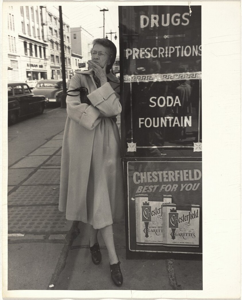 Woman beside drugstore--San Francisco
