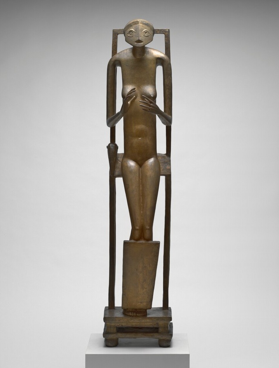 An abstracted, thin, nude woman with a round face half sits, half leans back against a tall, narrow support in this free-standing bronze sculpture. Her body faces us in this photograph. Her wide, oval face has two stylized, star-like eyes and a triangular opening for a mouth. The torso is tall and thin, and her limbs elongated. With thin arms, she holds up open hands with palms facing each other at the level of her round breasts. Her fingers are long and delicate. She is encased within a tall, rectangular frame. With knees slightly bent and resting against a panel that runs in front of her shins, she leans against a slat against her backside, perhaps the seat to a stylized chair. Her feet are pressed together on a double-tiered, low, square base with four bulbous feet at the corners.