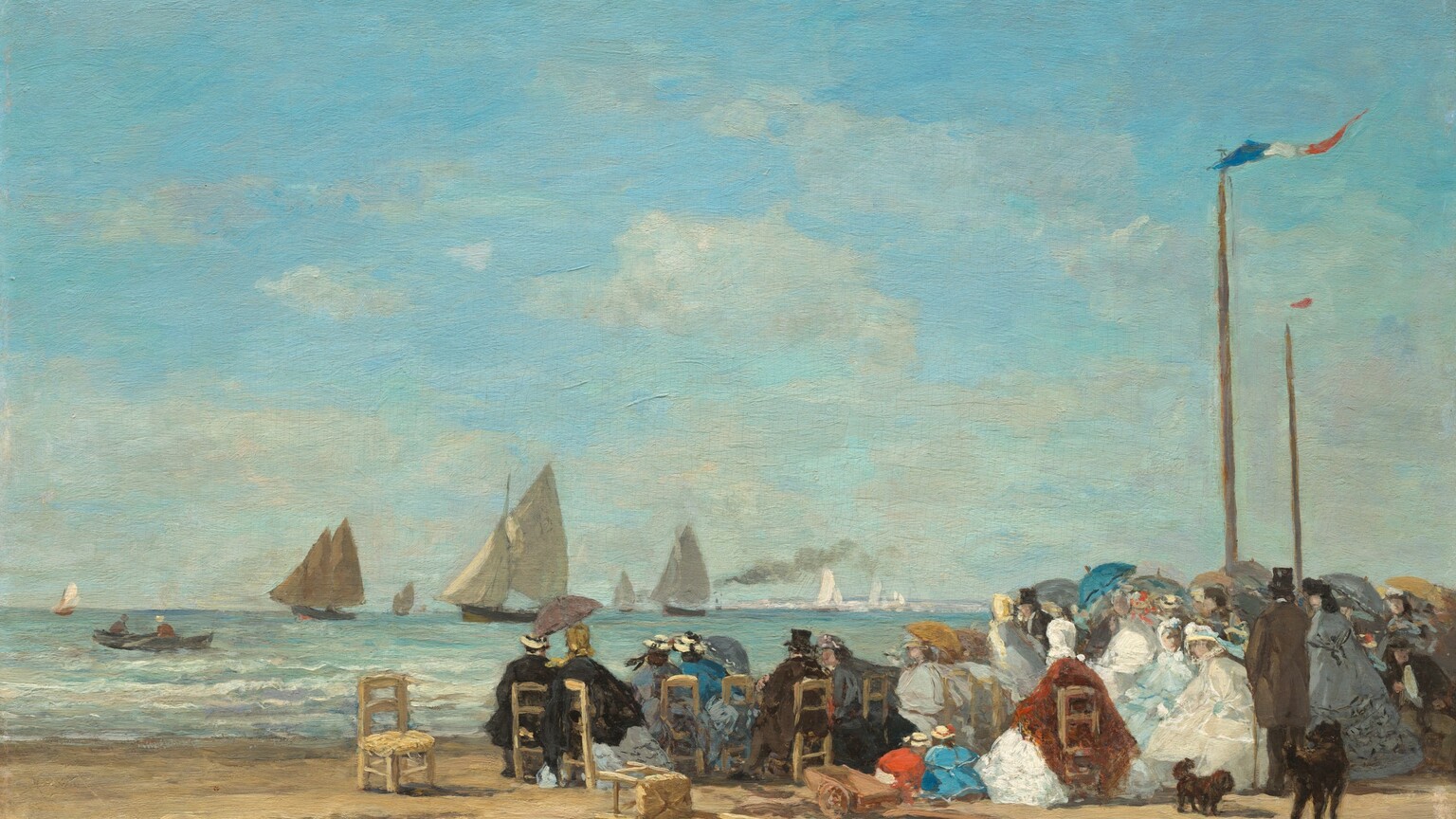 About two dozen men and women sit in straight-backed, wooden chairs gathered along a sandy beach near low, gently breaking waves with sailboats floating in the ocean beyond in this horizontal landscape painting. The scene is loosely painted throughout, making much of the detail indistinct. Most of the people sit with their backs to us but the faces we can see suggest they all have light skin. The people gather in a loose crowd that crosses the right two-thirds of the composition. The women wear long dresses with full skirts, their shoulders wrapped in matching shawls in black, smoke gray, royal or arctic blue, rust red, or cream white. Some wear straw-colored hats with black or baby-blue bands, and others wear scarves over their hair. The men also wear hats, most of them black top hats, and suits in black or pecan brown. Some people hold up parasols in harvest gold, slate blue, teal, or gray. A few straight-backed, wooden chairs with rushed seats sit empty or are tipped over to our left of the group. Two children, one wearing marigold orange and the other topaz blue, and both wearing straw hats, kneel or squat and bend over the sand at the center of the group. Two dark brown or black dogs, one small and one large, stand to our right. Two tall, wooden poles rise high above the crowd near the right edge of the composition. A thin banner with blue, white, and red stripes flutters from the pole closer to us, and a red banner lifts in the breeze on the one farther away. Painted with thick, visible brushstrokes, low waves with white crests lap against the shore in bands of pale lilac purple, light turquoise, and aquamarine blue just beyond the crowd. Two people sit in a rowboat in the ocean to our left, and several sailboats with tan sails move into the distance to the horizon, which comes about a quarter of the way up the composition. Bright white strokes to our right could be sails in bright sunlight, deep in the distance. One boat amid the sailboats puffs a plume of gray smoke. Pale, almost translucent white clouds drift across the light blue sky above. The artist signed and dated the painting in the lower left corner: “E. Boudin 63.”