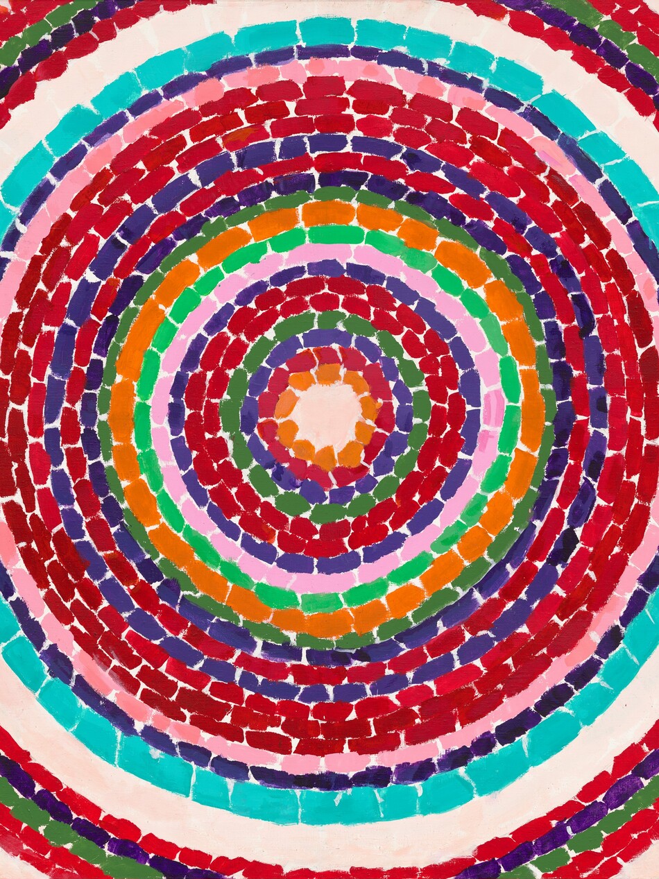 This nearly square, abstract painting is filled with circles within circles, like nested rings, each of a single bright color against the ivory white of the canvas. Each ring is made up of a series of short, rectangular dashes, and some bands are narrower while others are a bit wider. The majority of the rings are crimson and brick red, and they are interspersed with bands of lapis blue, army green, and pale pink. One of two pumpkin-orange bands is the smallest, innermost ring at the center. There is one aqua-blue colored ring just inside a pale, shell-white ring, which is the first to get cropped by the edges of the canvas. A few red, green, and blue rings beyond the white band are only seen at the corners of the canvas.