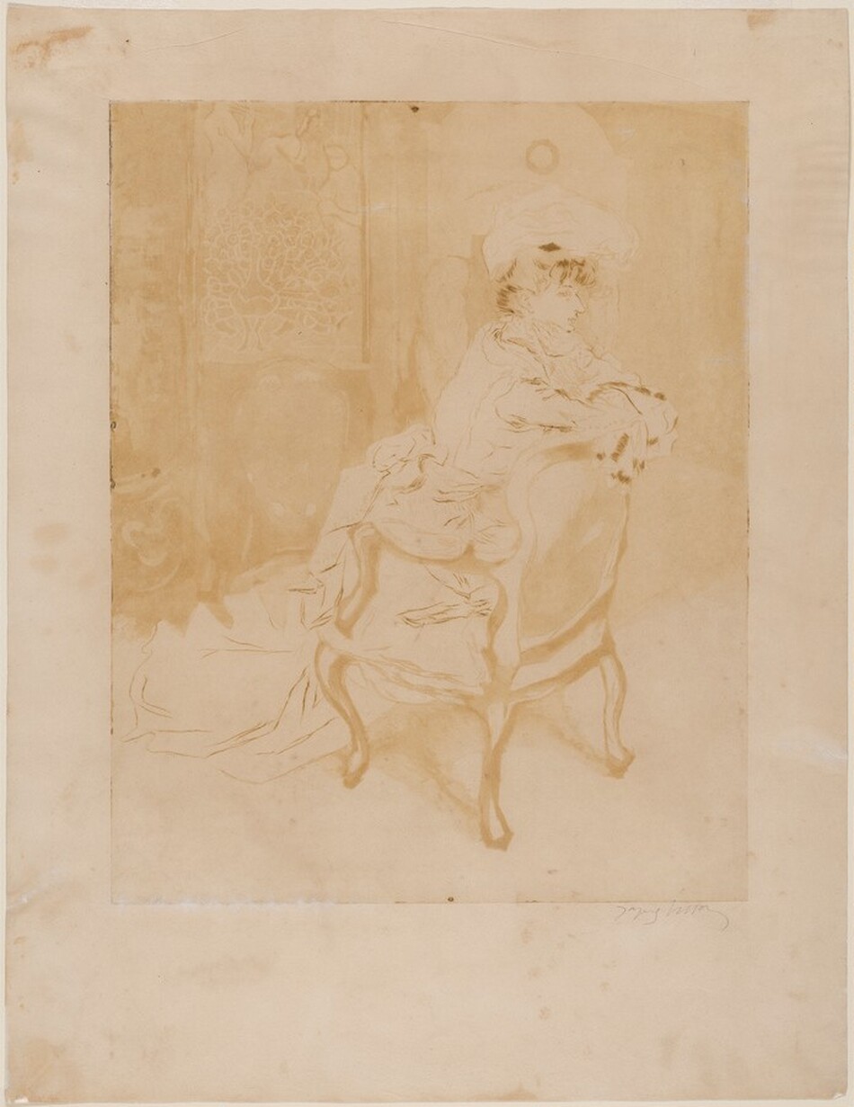 The image shows a woman seated, captured from her torso upwards, facing sideways with her body angled slightly to the right. Her features are softly rendered, and she has a delicate profile with a slightly turned-up nose. Her hair is styled in an updo, and possibly adorned with a hat or headpiece. She wears a long-sleeved garment that drapes around her with a substantial amount of fabric pooling on the ground. The attire suggests Victorian-era clothing with elaborate detailing such as fur cuffs. The chair she sits on has ornate, curved legs and a high back. In the background, there is a subtle artistic rendering resembling a decorative panel or wall hanging with a foliage or stylized nature motif. The image is in a monochromatic sepia tone.