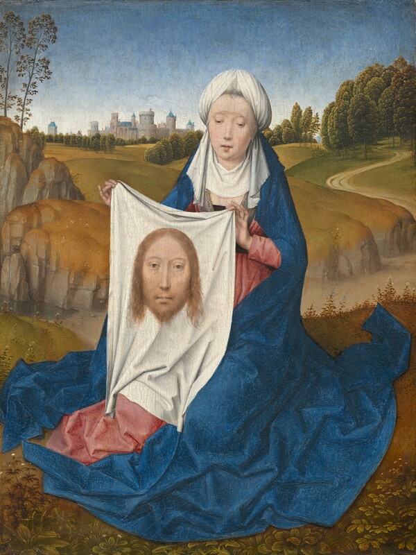A woman sitting close to us in front of a deep landscape holds up a white cloth with the image of a man’s face on it in this vertical painting. The woman and the image on the cloth both have pale skin, hooded eyes, and long, straight noses. The woman’s shoulders are squared toward us, and her legs are tucked under her. Her head tips slightly to our right. Her eyes are downcast, and her bow-shaped lips are parted. She wears a white, turban-like headdress with a white veil covering her neck and upper chest. Her rose-pink dress is mostly covered by a voluminous, lapis-blue robe falling from the back of the headdress to the ground, where it puddles in angular folds. On the white cloth she holds up, the man’s head has chin-length blond hair and a beard. He looks out at us with light brown eyes. The woman sits on a grassy field. A dirt path cuts through a shallow valley across the picture, not far behind the woman. More harvest-yellow and moss-green hills roll back to a town with gray stone buildings with blue roofs along the horizon, which comes three-quarters of the way up the composition. The sky above deepens from white at the horizon to azure blue across the top of the painting.