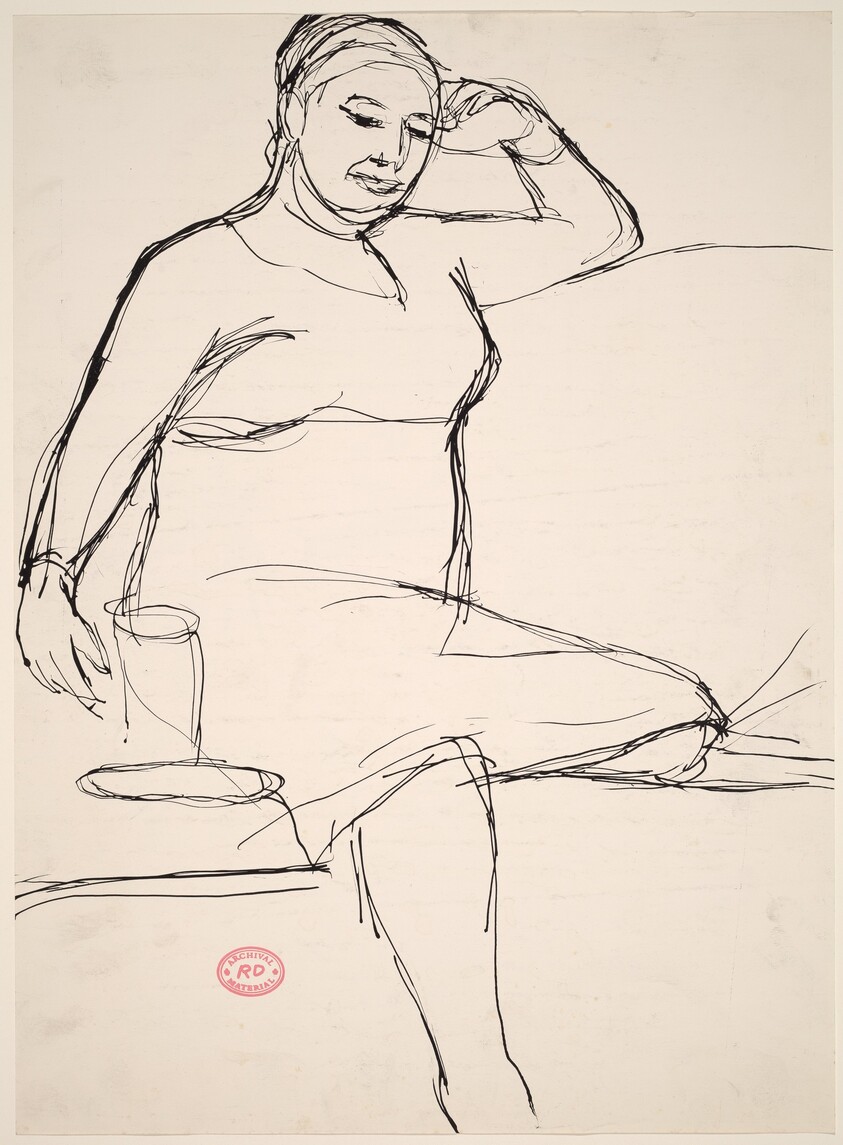 Untitled [woman seated on an arched-back sofa]