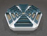 We look slightly down at a hexagonal, abstract sculpture made with teal-blue, wooden bins radiating out in six arms from a smaller hexagonal bin in the center. Each of the six arms tapers from wider and taller bins at the perimeter to narrower, shorter bins near the center. Light brown sand partially fills the bins. The bins sit on a white platform, the outlines of which follow the six sides of the snowflake-like arrangement of bins. The platform sits on battleship-gray carpet.