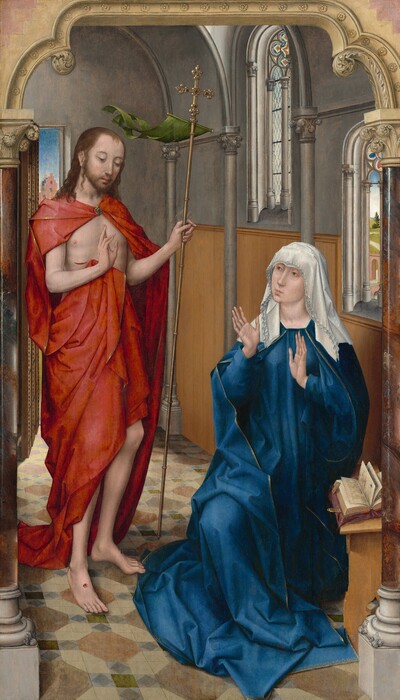 A woman wearing a cobalt-blue robe and a white veil sits with her hands raised, palms out, as she looks toward a slender, bearded man who stands to our left in this vertical painting. Both have light skin and delicate features, and they sit in a room with stone walls and arched windows. There are faint circles under the woman’s light brown eyes. She has a long slender nose, and her pink lips are pursed. One knee is bent, and she is low to the ground, suggesting she sits on a stool. A book lies open on a wooden stand in front of her to our right, below her left elbow. The ruffled edges of her multi-layered, white veil sweep over her forehead and down to her shoulders. Her loose, long-sleeved blue garment is edged with gold and falls in angular folds to pool at her feet. She holds her long-fingered, slender hands up at her chest, palms facing the man to our left. He stands with his body angled toward her as he looks down, his head tipped slightly forward. His brown hair falls over his shoulders. His voluminous, gold-edged, red cloak is fastened at his throat with a gold, jeweled brooch, and it drapes over his shoulders and around his lower torso, leaving his arms, chest, and a gash over his right ribs exposed. He holds a tall, gold staff topped with a jeweled cross in his left hand, to our right. A moss-green pennant flutters back from the base of the cross, as if lifted in a breeze. The man holds up his other hand so the palm faces the woman with the first two fingers raised. Round, puncture wounds with red blood mark the palm of that hand and tops of both bare feet. The floor is patterned with gray, brown, blue, and green tiles. The wall behind the woman has honey-brown paneling along the bottom half and the top half is slate gray. Gray columns are spaced along that wall, supporting a curving, vaulted ceiling. Two arched windows pierce the wall behind the woman, and both have stained glass designs within the curving tops. The window closer to us opens onto a narrow view of a landscape with a rose-pink arch over a bridge, and a path winding through green fields. An open door over the shoulder of the man, to our left, shows the stepped roofline of a pink building under a blue sky. The entire scene is framed with a flattened arch supported by gleaming columns of polished, veined brown stone, creating the impression that we look onto the people and room through the arch. The columns have leafy capitals and white bases. The tan-colored arch is carved with a row of stylized rosettes along the opening that spans the top of the painting.