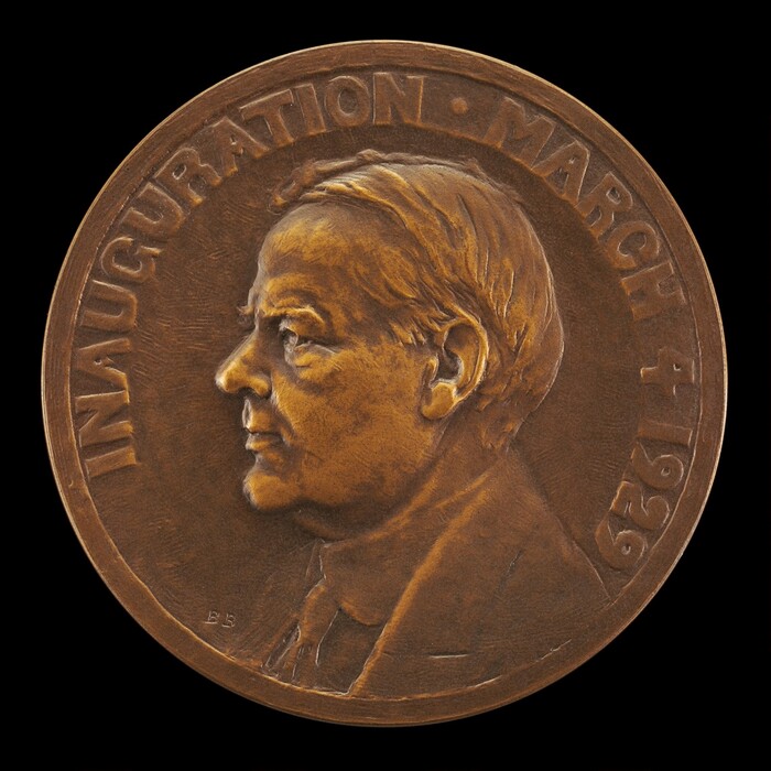 The sculpture is a bronze medallion with a profile relief of a man's head and shoulders facing left. The man has short, neatly combed hair, a prominent nose, and a thoughtful expression. The medallion is circular with a detailed texture, enhancing its three-dimensional depth. It features the inscription "INAUGURATION - MARCH 4, 1929." The bronze color catches light, highlighting the embossed figure's contours. The medallion appears to be handheld or displayed as a collectible item.