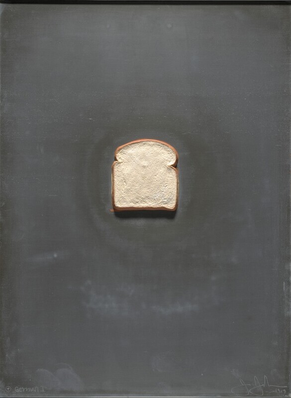 A piece of white bread sits against a charcoal-gray, vertical, rectangular field. The piece is cast in lead, and the bread painted. Incised in the lower left corner, an inscription reads, “Gemini I.” To the right, a second incised inscription reads “J Johns 1969.”