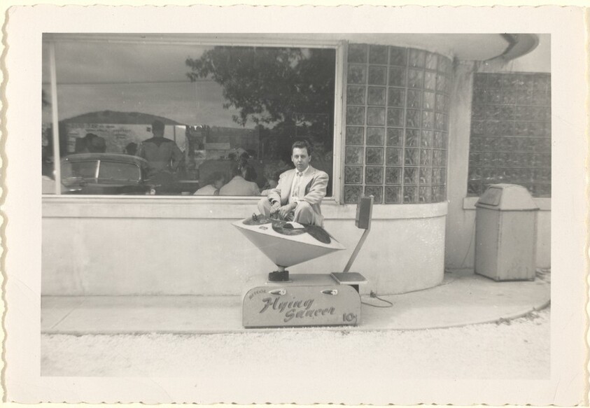 Untitled (Man in toy flying saucer)