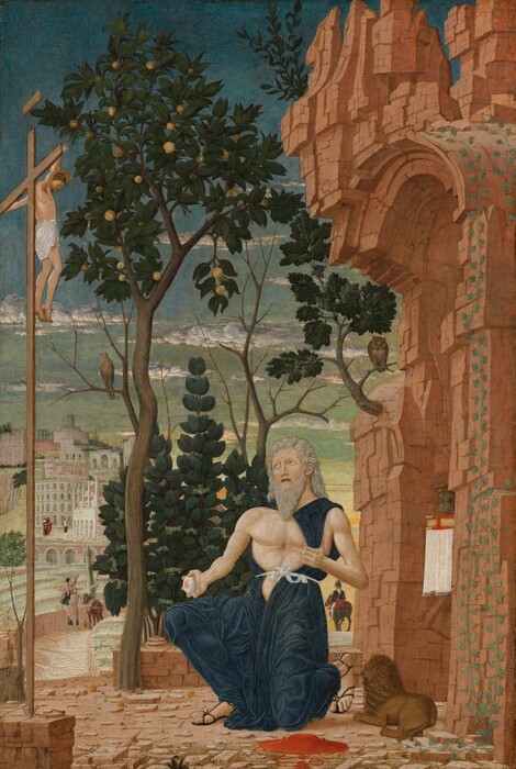 In front of a crumbling stone building, an older man kneels in front of a second man, smaller in scale, hanging from a tall, wooden cross, with a city in the background in this vertical painting. Both men have pale skin. At the lower center of the composition, the kneeling man, Saint Jerome, pulls his navy-blue robe to one side to expose his muscular but slender bare chest with a bloody mark at its center. With his other hand, he holds a rounded, gray stone touched with pink, also suggesting blood, by his side. He has long, silvery-gray hair and a long, pointed beard. His pink lips are parted, and we see his teeth. He raises gray eyes to look up at the man on the slender cross, which rises along the left edge of the composition. The man on the cross brown hair, a plate-like gold halo, and a white loincloth is draped across his hips. The shell-pink ground is littered with rocks. A red hat with a shallow brim and a tasseled chin cord sits near Saint Jerome’s sandaled feet. A miniature lion lies between Saint Jerome and the arched opening of the crumbling, terracotta-red structure along the right edge of the painting. Ivy grows up one side of the arch, and an hourglass and book with a red cover and gold-edged pages sit on a white cloth under the opening. An owl perches on a branch of an oak tree growing from the front face of the structure, and a hawk sits on a branch of the fruit tree growing from the stone courtyard, between Saint Jerome and the crucifix. A shrub with dark green leaves and clusters of three olive-green fruits fills in most of the space beneath the canopy of the fruit tree. To our right and in the distance, a man with a pointed black hat, a black jacket, and white pants rides away from us on a gray horse. To our left, the courtyard gives way to an amphitheater-like space. There, next to a donkey, a man with a long white beard hands a bundle of wood or planks to another man whose brown hair is cut into a ring encircling his head. Both men wear rose-pink garments over navy-blue togas. A town with white and pale pink stone buildings rises up a hill into the distance. The sky above deepens from honeydew green along the horizon to pale then peacock blue along the top edge of the composition. A few ice-blue, white, and light gray clouds float across the sky.