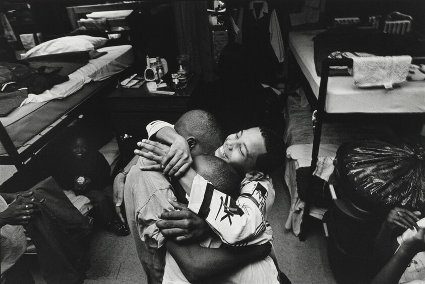 Boys in the shelter hug Pierre Garrett after a tearful confrontation with his mother. Olive Branch Mission, Chicago.