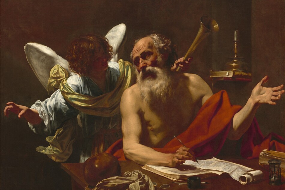 Shown from the waist up, an elderly, balding, light-skinned man with a bushy white beard sits behind a table, facing us, in front of a winged angel who looks on in this shadowy, horizontal painting. The man sits with his body angled slightly to our right, and he turns his head to look in the opposite direction. His eyes are sunk in shadow under deeply furrowed brows, set in his lined face. His sparse, gray and white hair is tousled. He wears only a scarlet-red cloth draped across his lap and over his sinewy left arm, on our right. His open left hand is raised, palm up, at shoulder height. In his other hand, he holds a pen, hovering over a partially unwound scroll. His forearm rests on an open book beneath the scroll. He looks over his right shoulder at the curly-haired angel with snow-white wings. The angel wears a flowing, light blue robe with a golden yellow cloth draped around the chest and over the shoulders. Softly smiling, the backlit angel leans toward the man, face deep in shadow. With arms lifted, one hand gestures with a slightly crooked finger, pointing beyond the picture’s border to our left. In the other hand, the angel holds a golden horn in the dusky background behind the man’s left shoulder. Behind the man and angel and to our right, a single candle sits on two books lying in an arched wall niche. On the desk closest to us are a crumpled cloth on a book, a shiny rust-brown ball, a pair of eyeglasses, an inkpot, an hourglass, and a second book, to our right. Light coming from our upper left starkly illuminates the two people against the shadowed, earth-brown background.