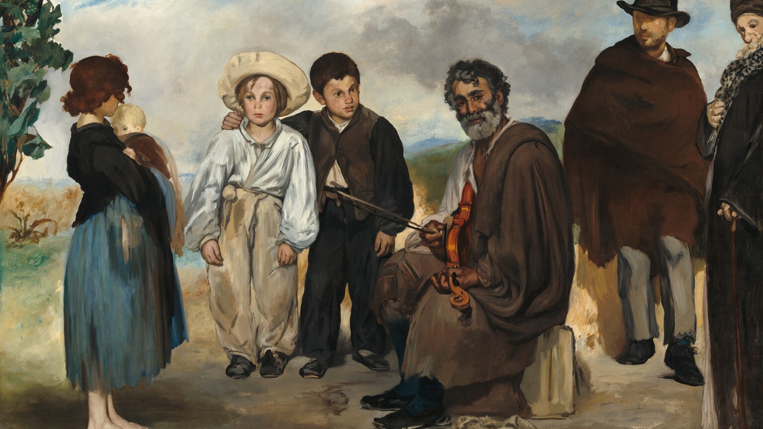 Against a hilly landscape and on a patch of dirt, five people wearing tattered clothing gather around a bearded man who holds a violin in his lap in this horizontal painting. Most of them have pale skin. Starting from the left is a barefoot young woman holding a blond baby to her chest. She faces our right, and her chestnut-brown hair hides her profile. She wears a black shirt over a calf-length skirt streaked with slate and aquamarine blue. To the right two young boys face us. The boy on the left of that pair wears a loose white shirt tucked into tan-colored pants and an upturned wide-brimmed hat. The boy next to him has short brown hair and is dressed in a black and brown vest and pants over a bone-white shirt. His right arm, to our left, is slung across the shoulders of the blond boy and he looks off to our right with dark, unfocused eyes. The man who holds the violin is to our right of center. He sits on a stone with his body facing our left, but he turns to look at us with dark eyes under heavy brows. He has tan skin, dark gray, curly hair, and a trimmed silvery gray beard. A wrinkle under one eye suggests he may smile slightly at us. He wears a loose brown cloak with a ragged bottom hem, teal-blue stockings, and black shoes. He holds a violin on his lap like a guitar. One hand fingers a chord on the neck of the violin, which comes toward us, and the other hand holds the bow and plucks a string. A sand-colored bag with a strap lies at his feet. Two men stand to our right of the musician. One wears a tall black top hat, a brown cloak, gray pants, and black shoes. His face is loosely and indistinctly painted but he has a beard. Finally, the sixth person is a man who stands along the right side of the painting and is cut off by that edge. He wears a turban, a black polka-dotted scarf, and a long black cloak or coat. One hand clutches the scarf and the other rests on a wooden cane by his side. His chin and long, light-colored beard tuck back against the scarf, and he looks off to our left with dark eyes. There are loosely painted olive and forest-green leaves in the upper left corner. The landscape beyond is painted with indistinct areas of muted green, blue, and brown. Bits of azure-blue sky peek through puffy white and gray clouds overhead. The artist signed and dated the lower right, “ed. Manet 1862.”