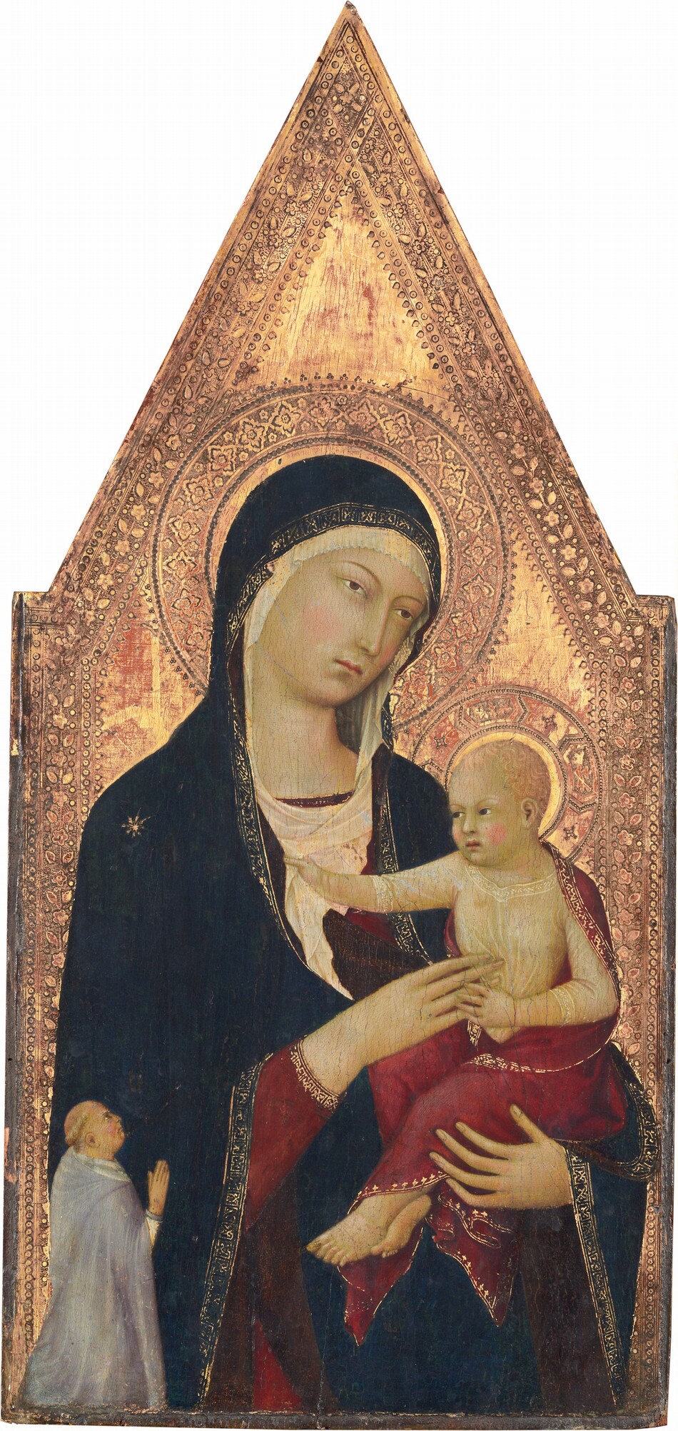 Shown from the hips up, a young woman holds an upright baby against a richly patterned gold background in this vertical panel painting, which comes to a point at the top center. The woman nearly fills the panel, and she looms over a very small man kneeling in the lower left, facing our right in profile. The people all have ivory-white skin with a greenish cast, and petal-pink cheeks. The woman’s body faces us, supporting the baby in the curve of her left arm, our right. Thin, tawny-brown eyebrows arch over her hazel, almond-shaped eyes, which gaze off to our right. She has a long, narrow nose and small rose-pink mouth. Her head tilts to our right and is covered by an ivory-white cloth that frames her round face and wraps around the neckline of her burgundy-red gown. Over the white cloth and red dress, a long, midnight-blue mantle trimmed with gold covers her head, shoulders, and arms. A gold starburst adorns one shoulder. Tucked in the woman’s elbow to our right, the baby faces our left and wears a sheer garment covered by a burgundy-red, gold-edged cloth draped across his shoulders, back, and legs. The child has short, wavy, peach-colored hair and echos the woman’s thin eyebrows and hazel eyes. He reaches out with his right hand, to our left, to clutch her scarf while his other hand delicately touches the fingers of her hand, which brushes his chest. The man in the lower left is significantly smaller in scale so his kneeling body comes only up to the woman's elbow. His blond hair is cut in a ring above the ears, and he wears a dove-gray cloak with a long hood falling back over his shoulders. His right hand is raised, fingers extended, and he tilts his head up to look at the woman. Intricate, patterned halos surrounding the heads of the woman and child are punched and incised into the gold background. A decorative border of flowers, leaves, and dots line the sides of the panel and meet at the pointed top. Areas of brick red show through some areas of the gold background.