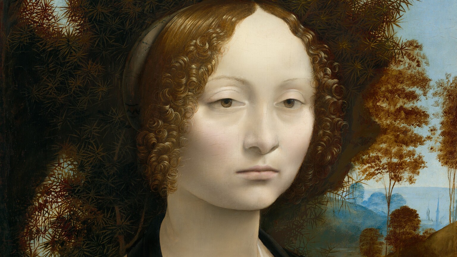 This square portrait shows the head and shoulders of a young woman in front of a spiky bush that fills much of the background except for a landscape view that extends into the deep distance to our right. The woman's body is angled to our right but her face turns to us. She has chalk-white, smooth skin with heavily lidded, light brown eyes, and her pale pink lips are closed. Pale blush highlights her cheeks, and she looks either at us or very slightly away from our eyes. Her brown hair is parted down the middle and pulled back, but tight, lively curls frame her face. Her hair turns gold where the light shines on it. She wears a brown dress, trimmed along the square neckline with gold. The front of the bodice is tied with a blue ribbon, and the lacing holes are also edged with gold. A sheer white veil covers her chest and is pinned at the center with a small gold ball. The bush fills the space around her head with copper-brown, spiky leaves. A river winds between trees and rolling hills in the distance to our right. Trees and a town along the horizon, which comes about halfway up the painting, is pale blue under an ice-blue sky.