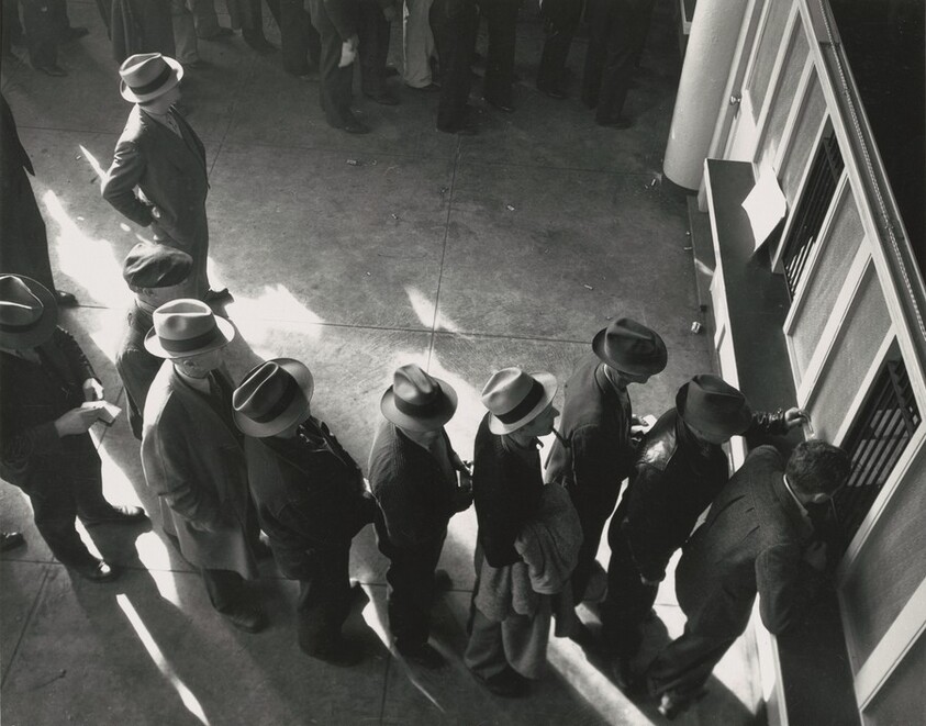 Line of men inside a division office of the State Employment Service office at San Francisco, California, waiting to register for unemployment benefits
